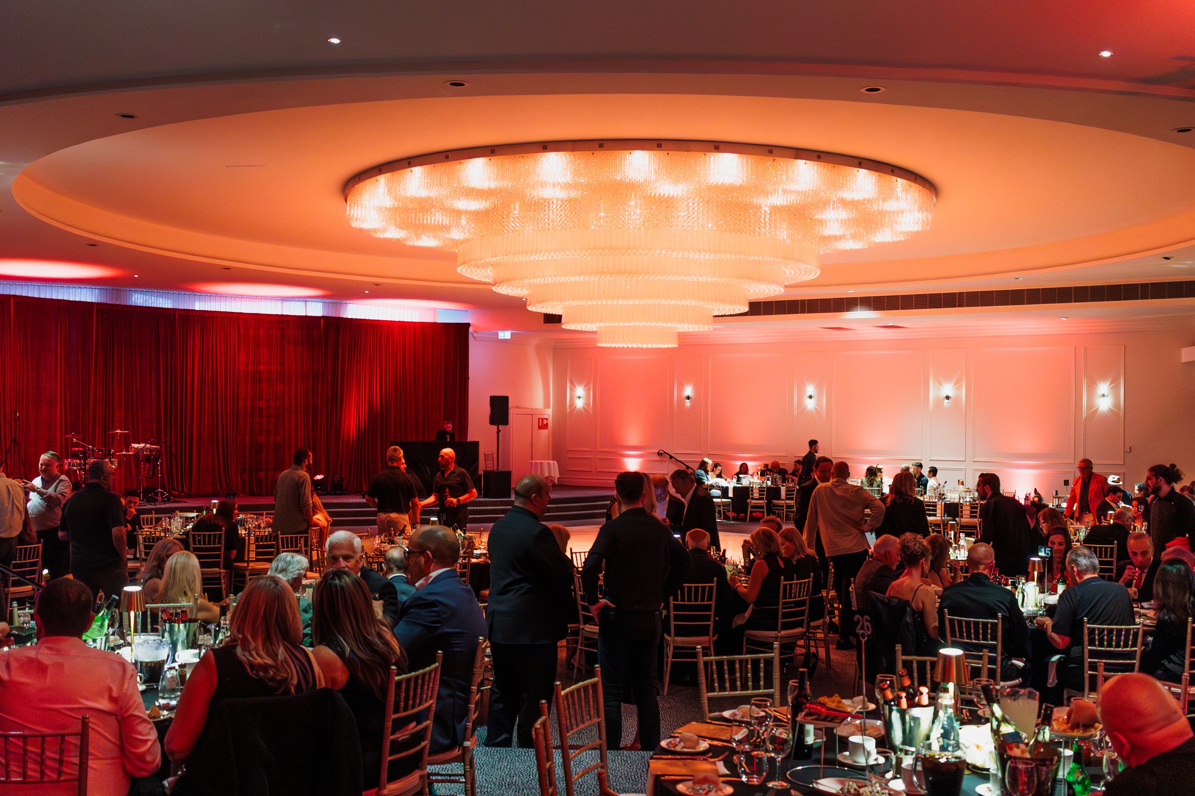 Guests seated for dinner in the Melrose ballroom beneath the chandelier