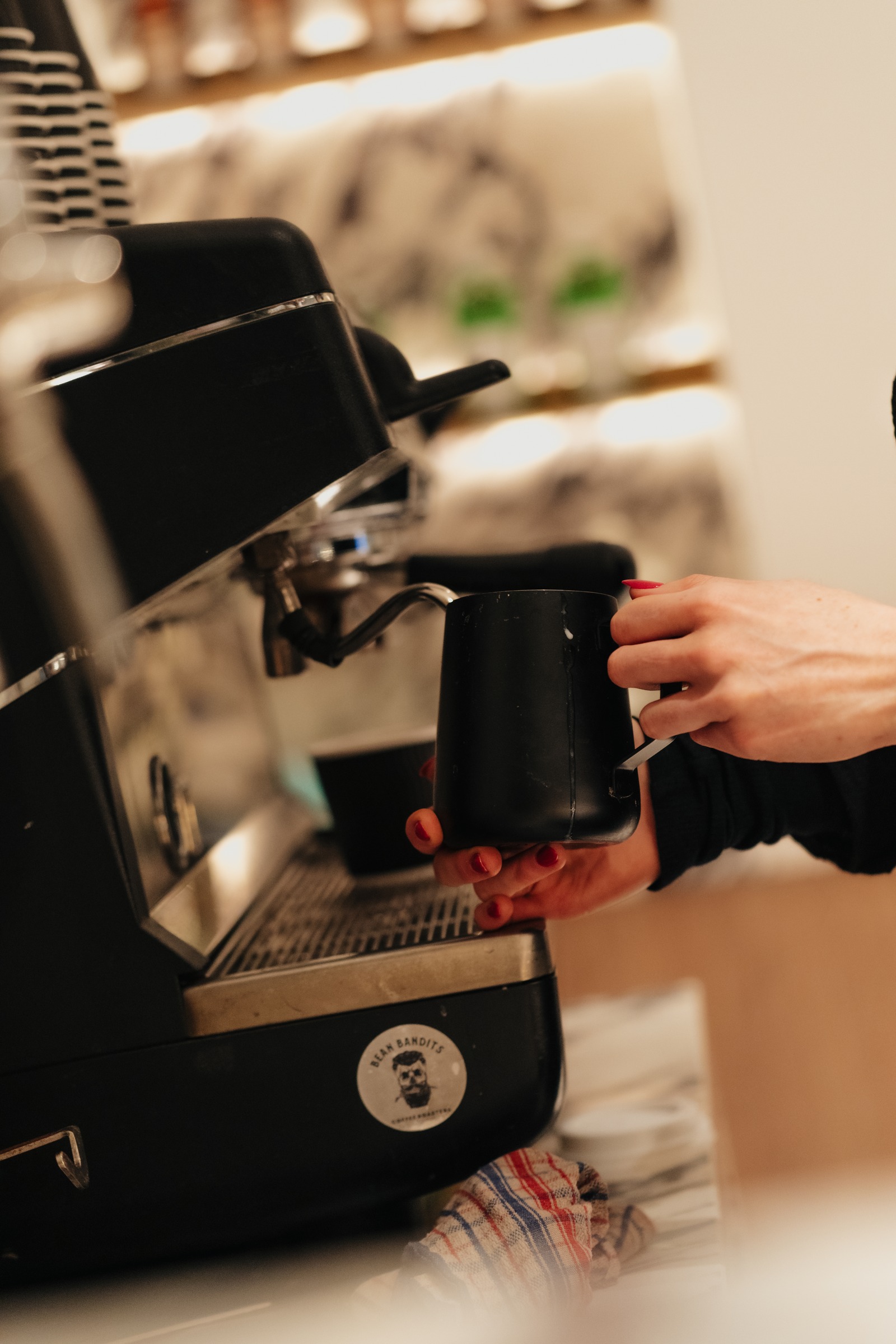 Barista steaming milk on the espresso machine at Melrose Events