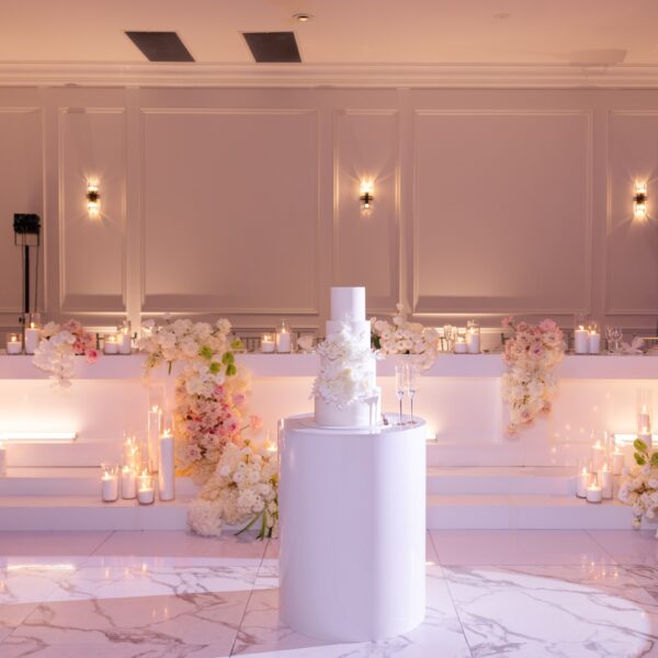 White wedding cake and floral bridal table in the Melrose reception room