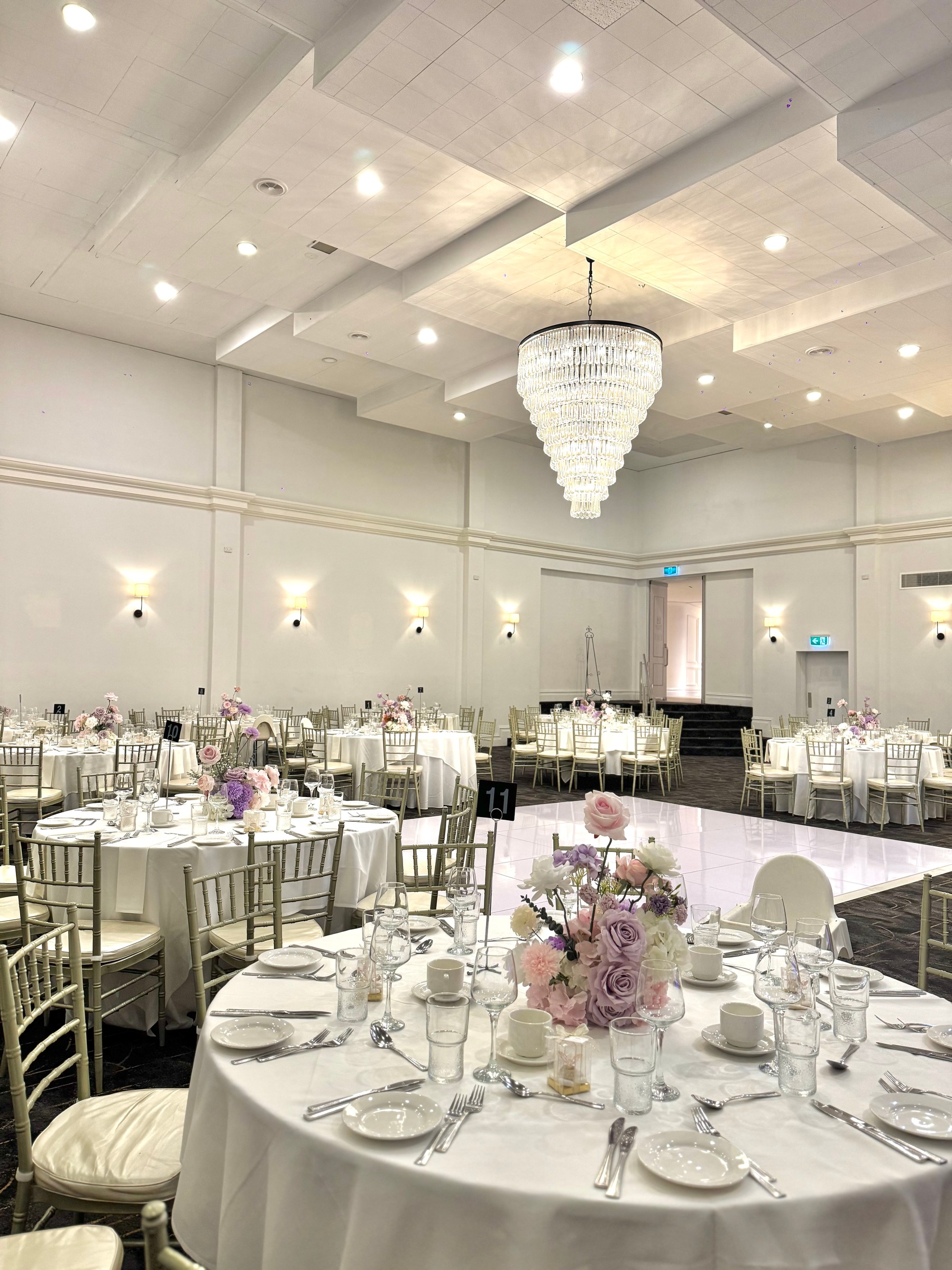 Magnolia Room at Melrose Events set with round tables and florals for a christening