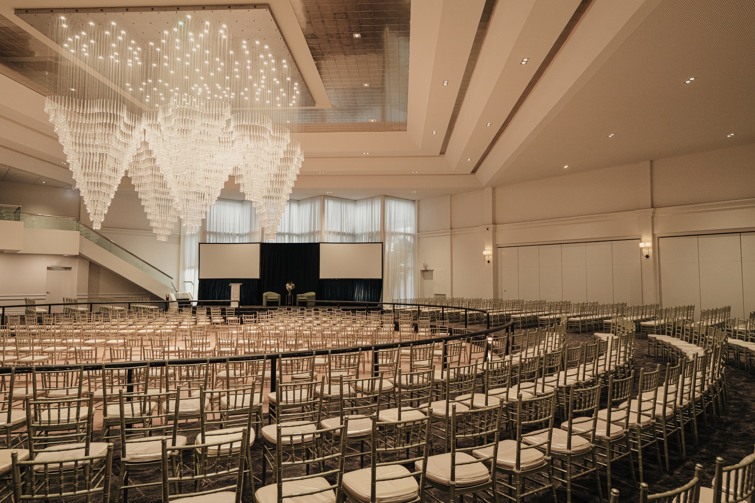 Grand Ballroom at Melrose Events set theatre-style beneath the tiered crystal chandelier
