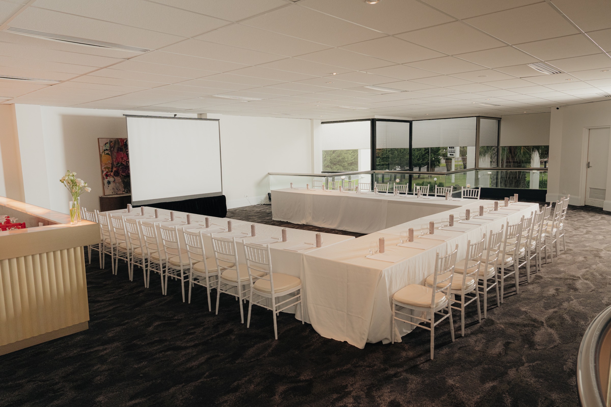 Grand Ballroom Mezzanine set with U-shape tables beside floor-to-ceiling windows