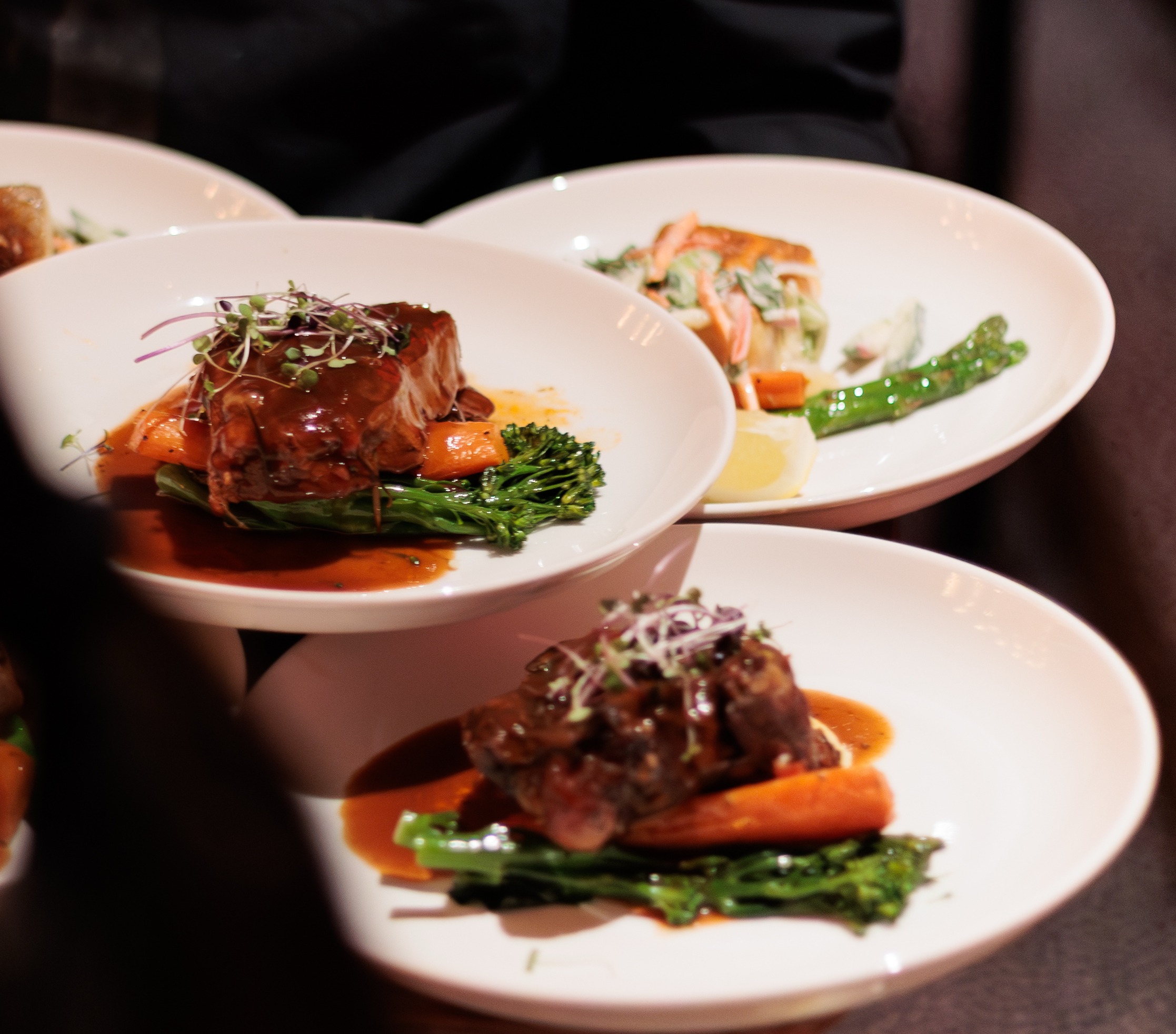 Plated beef with broccolini and jus ready for service