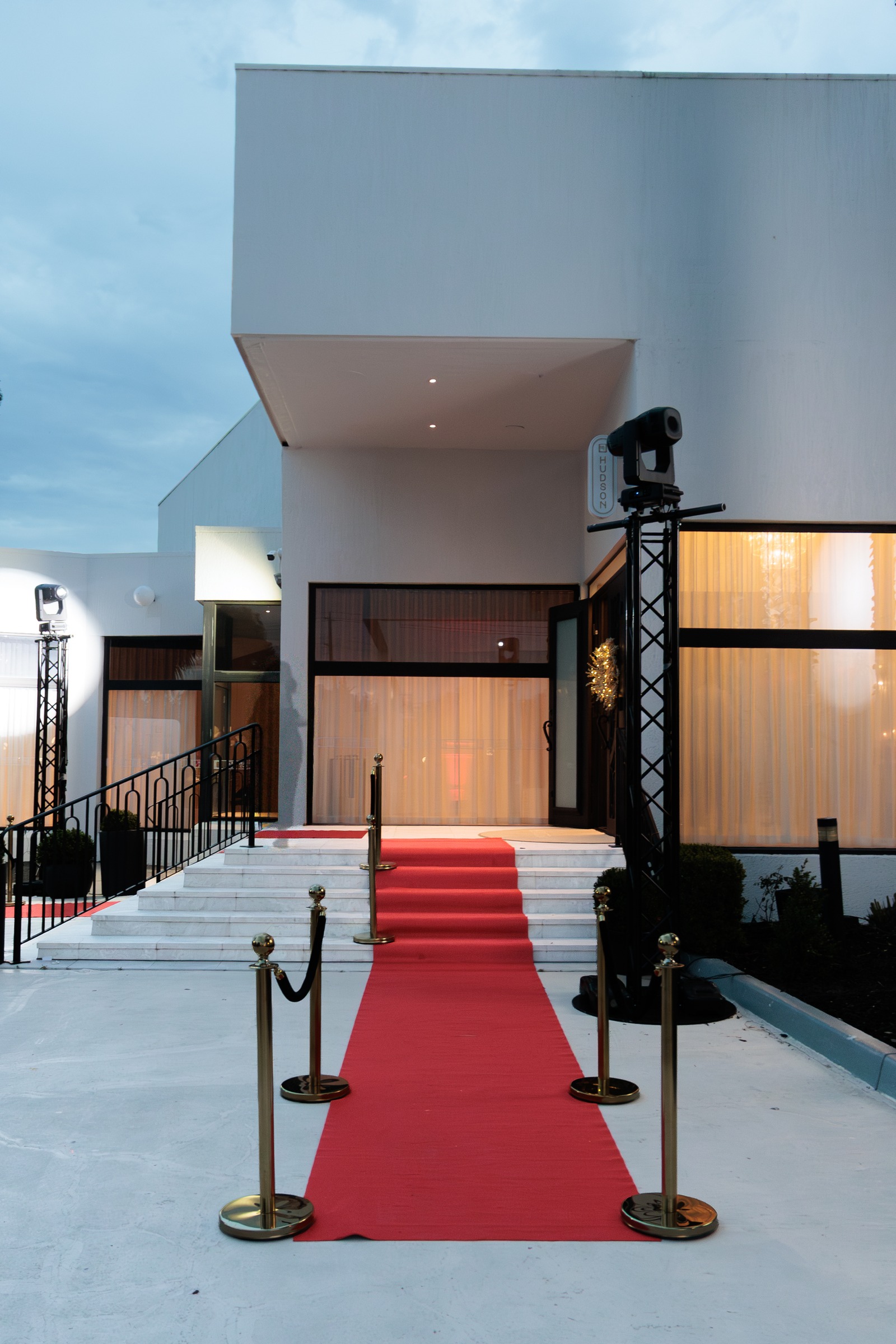 Red carpet and gold bollards leading up the steps to the Melrose entrance